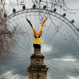 Royal Air Force Memorial with the London Eye. Unveiled in 1923 to commemorate the casualties of the Royal Air Force in WW1 - and by extension to all subsequent conflicts. The eagle was designed by William Reid Dick