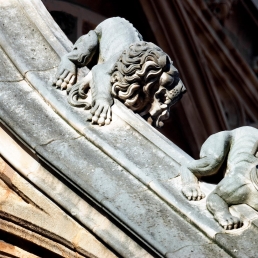 Medieval lion and dog whizzing down a flying buttress on Westminster Abbey.