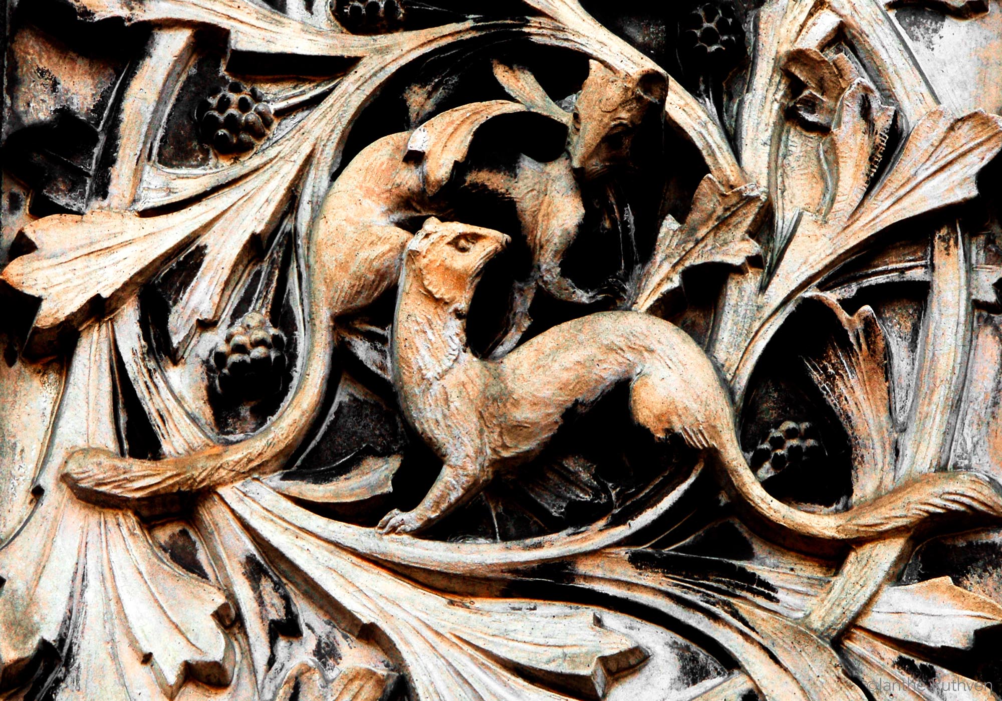 Terracotta bas-relief of weasels on the front gates of the National History Museum, SW7, designed by Alfred Waterhouse (1875-6).